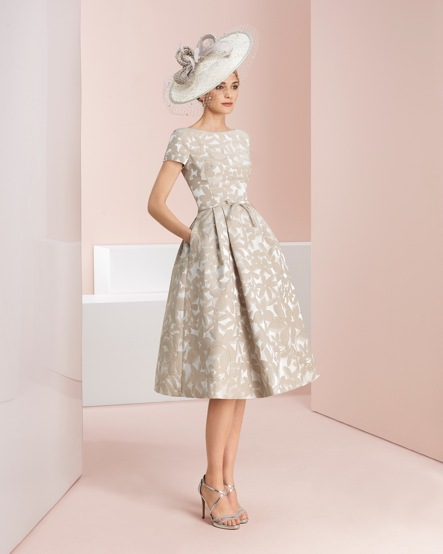 Vestido de fiesta corto y chaqueta de brocado, en manga corta , bolsillos y lazo en la cintura.. Disponible en colores arena, rosa y amarillo. Colección COUTURE CLUB 2018.