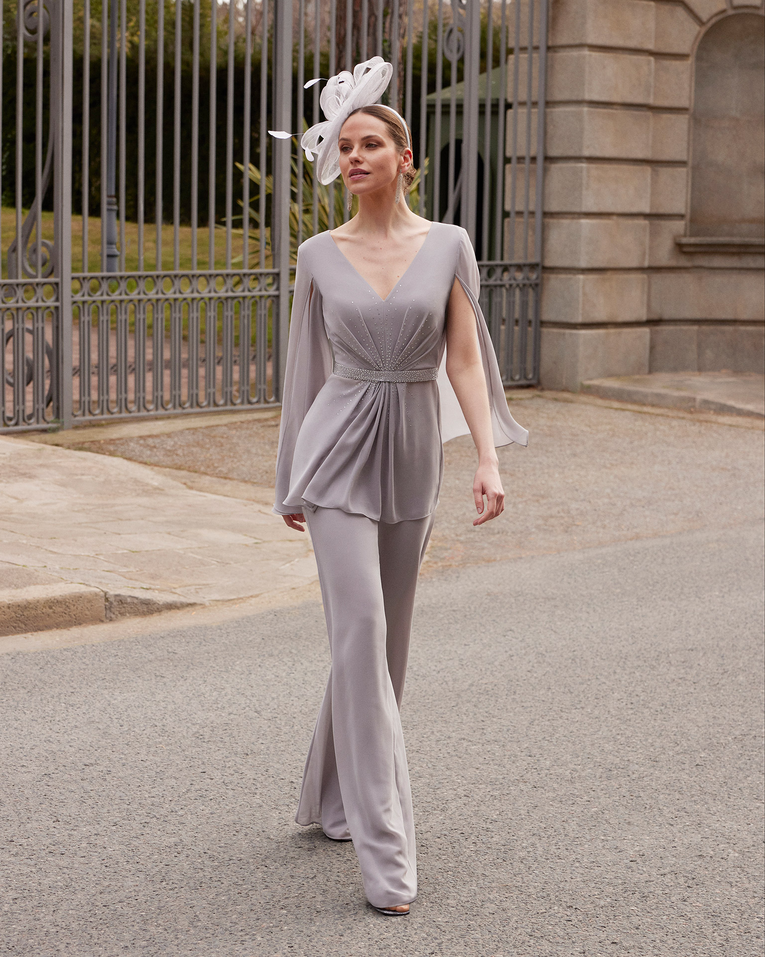 Long evening jumpsuit made of georgette. Couture Club design with a V-neckline, long sleeves, and beadwork details at the waist and bodice. MARFIL_BARCELONA.
