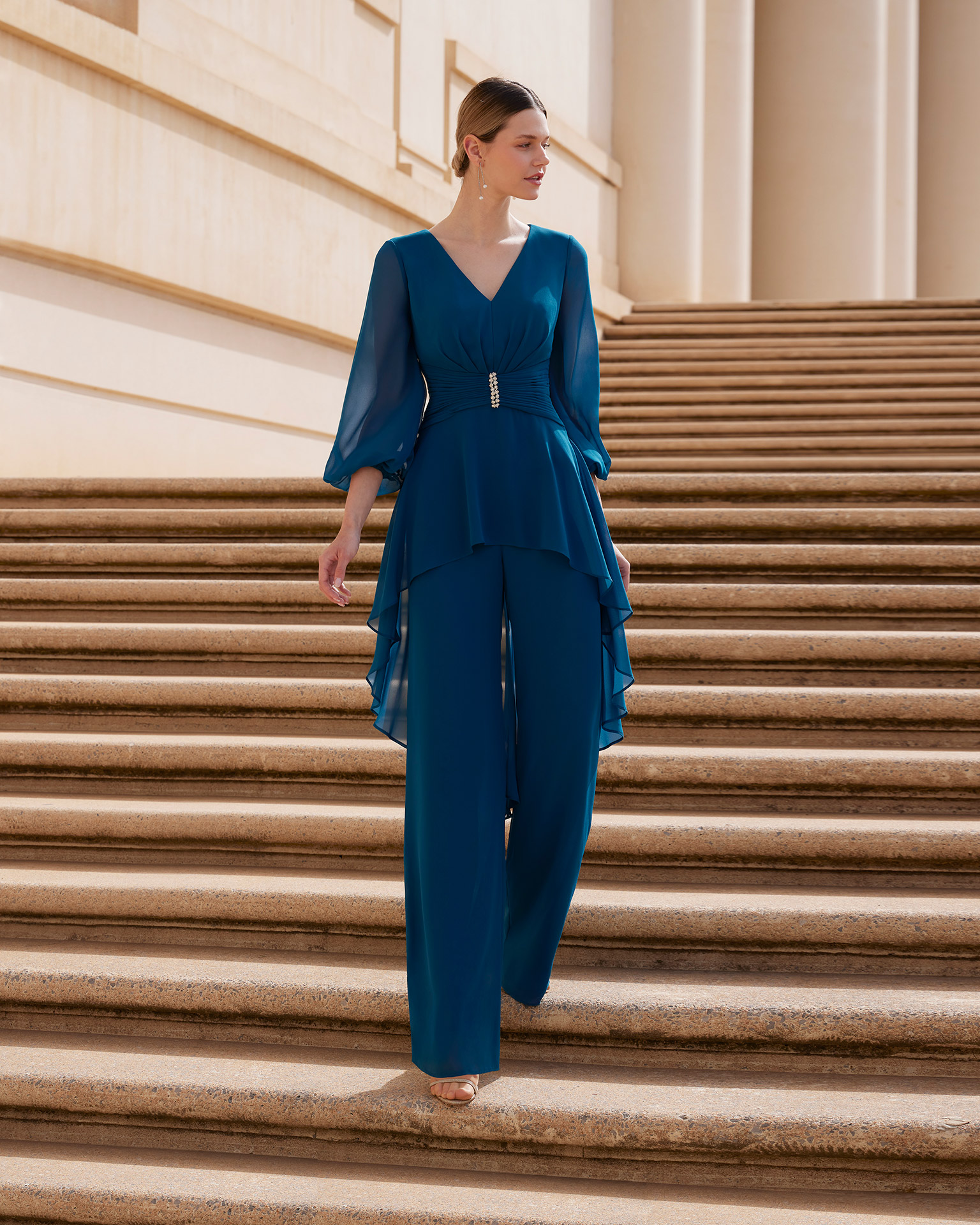 Evening dress and trousers made in georgette. Couture Club design with three-quarter sleeve blouse with beadwork details at the waist. MARFIL_BARCELONA.