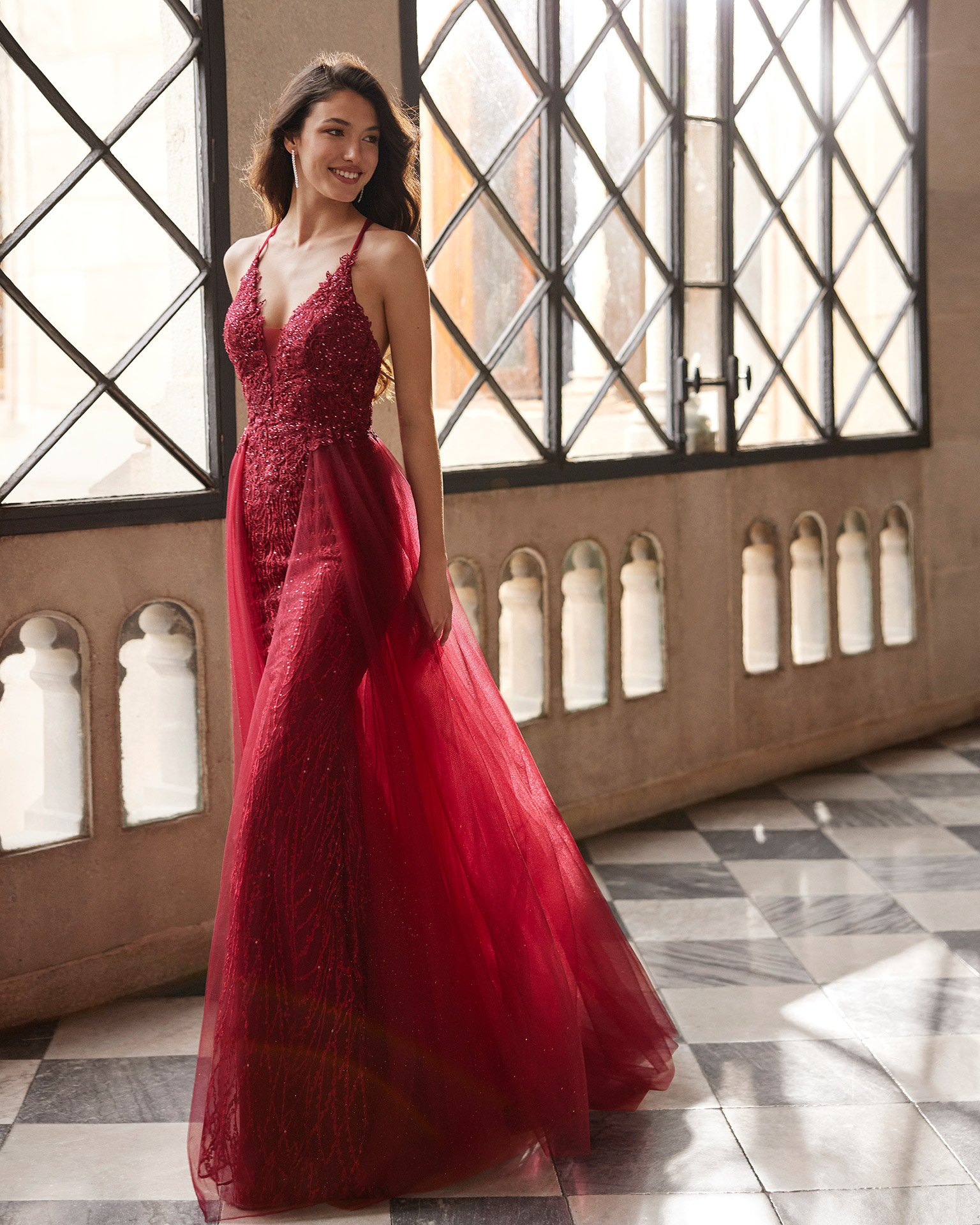 Romantic long evening dress made of lace with beadwork. Marfil Barcelona design with a plunging V-neckline, a tulle skirt, and a back with straps. MARFIL_BARCELONA.