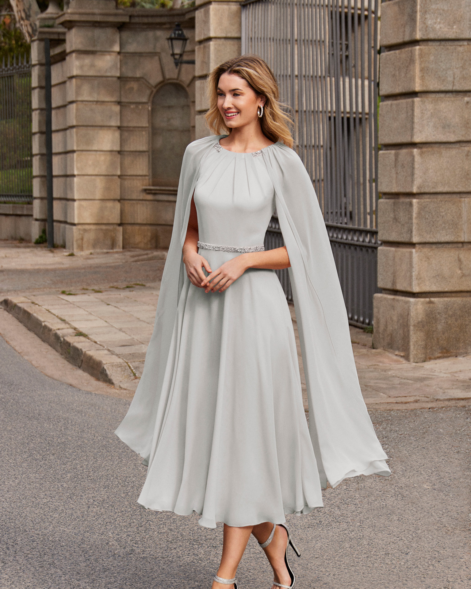 Short cocktail dress made of georgette. Couture Club design with a round neckline, long cape sleeves, and beadwork details at the waist and neckline. MARFIL_BARCELONA.
