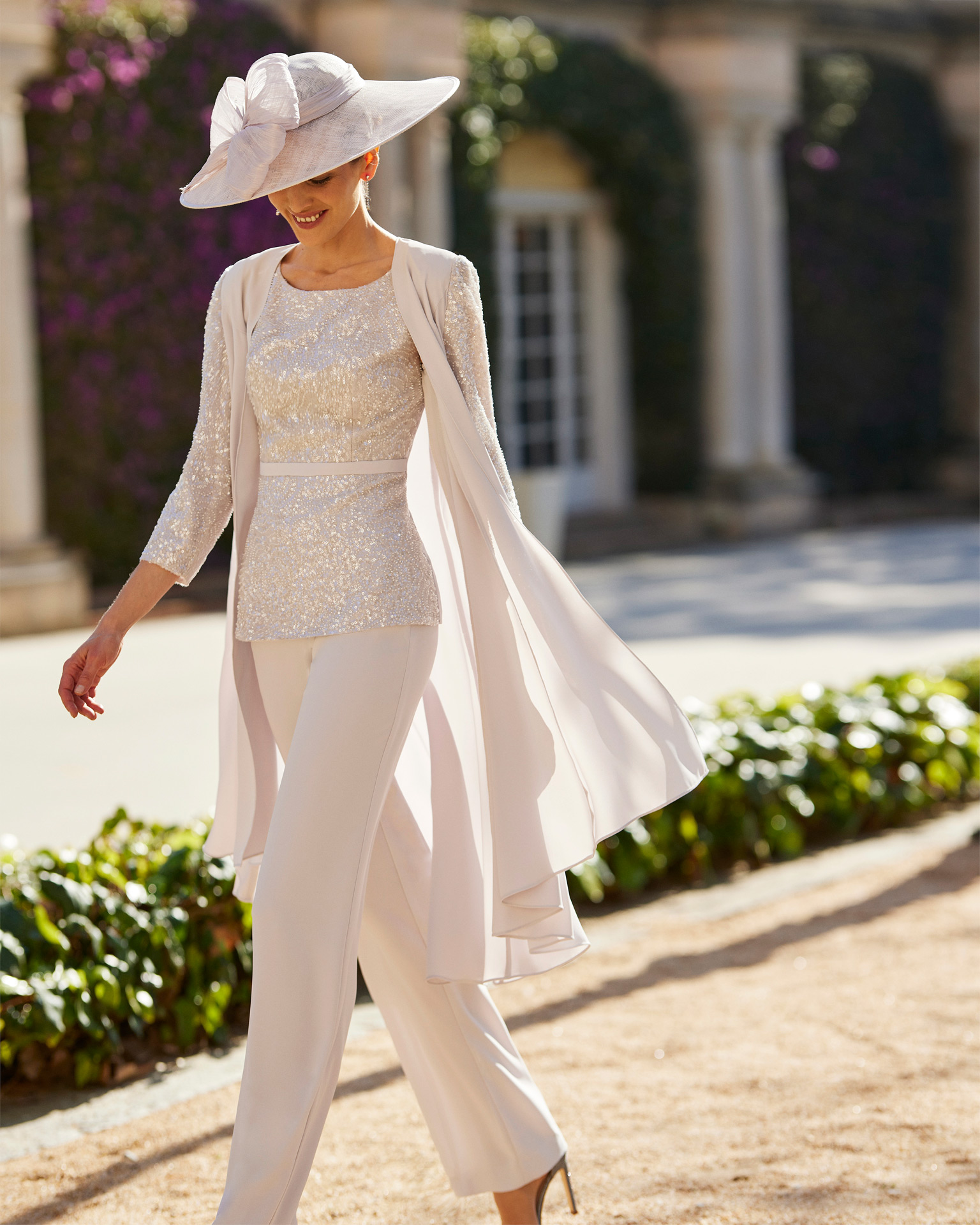 Modern cocktail pantsuit. Crafted in crêpe combined with beadwork. With round neckline, straps and jacket. Couture Club outfit for parties and events. MARFIL_BARCELONA.