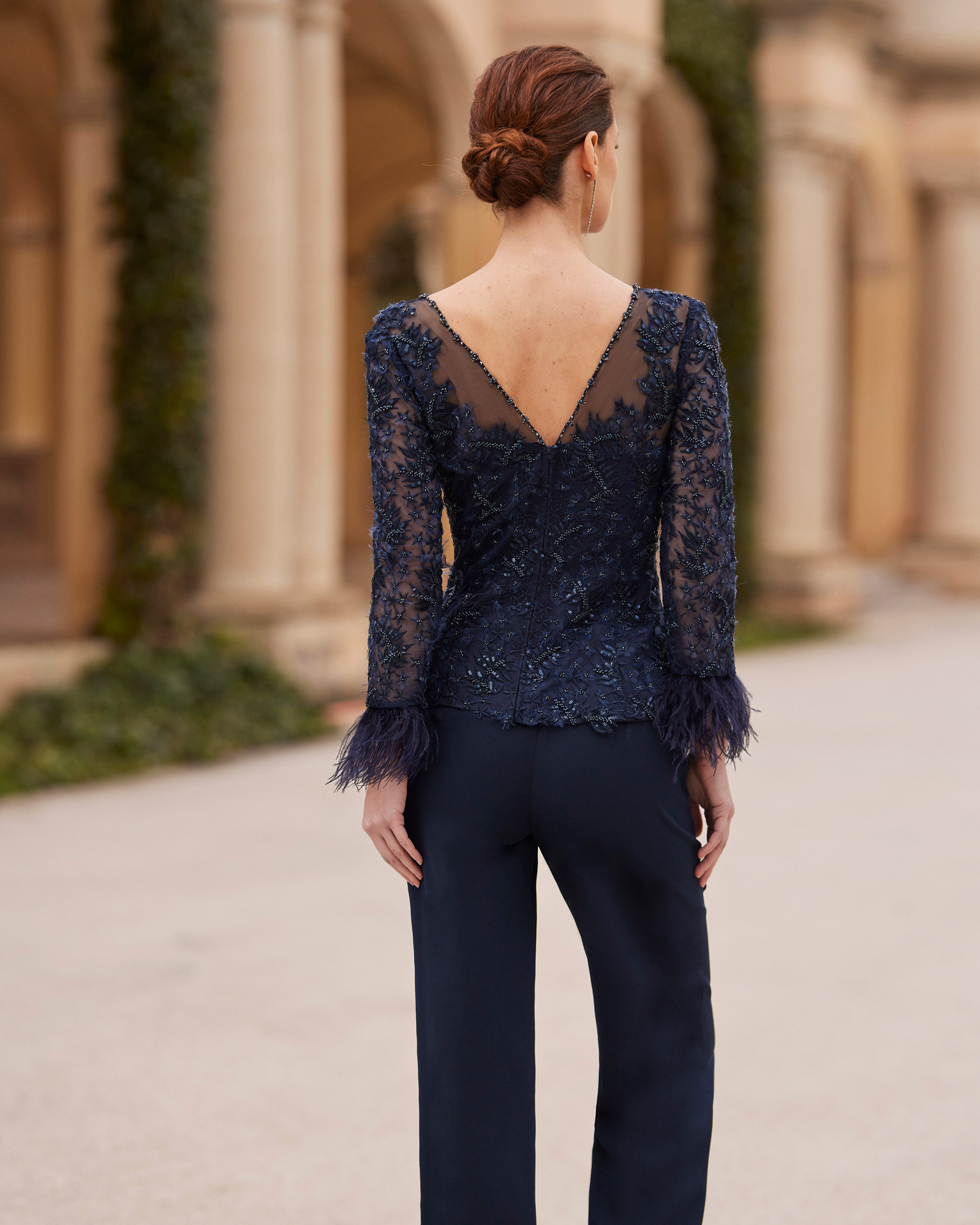 Modern evening pantsuit. Made with crêpe and beadwork lace. With bateau neckline and long sleeves with feathers, combined with jacket. Couture Club outfit. MARFIL_BARCELONA.