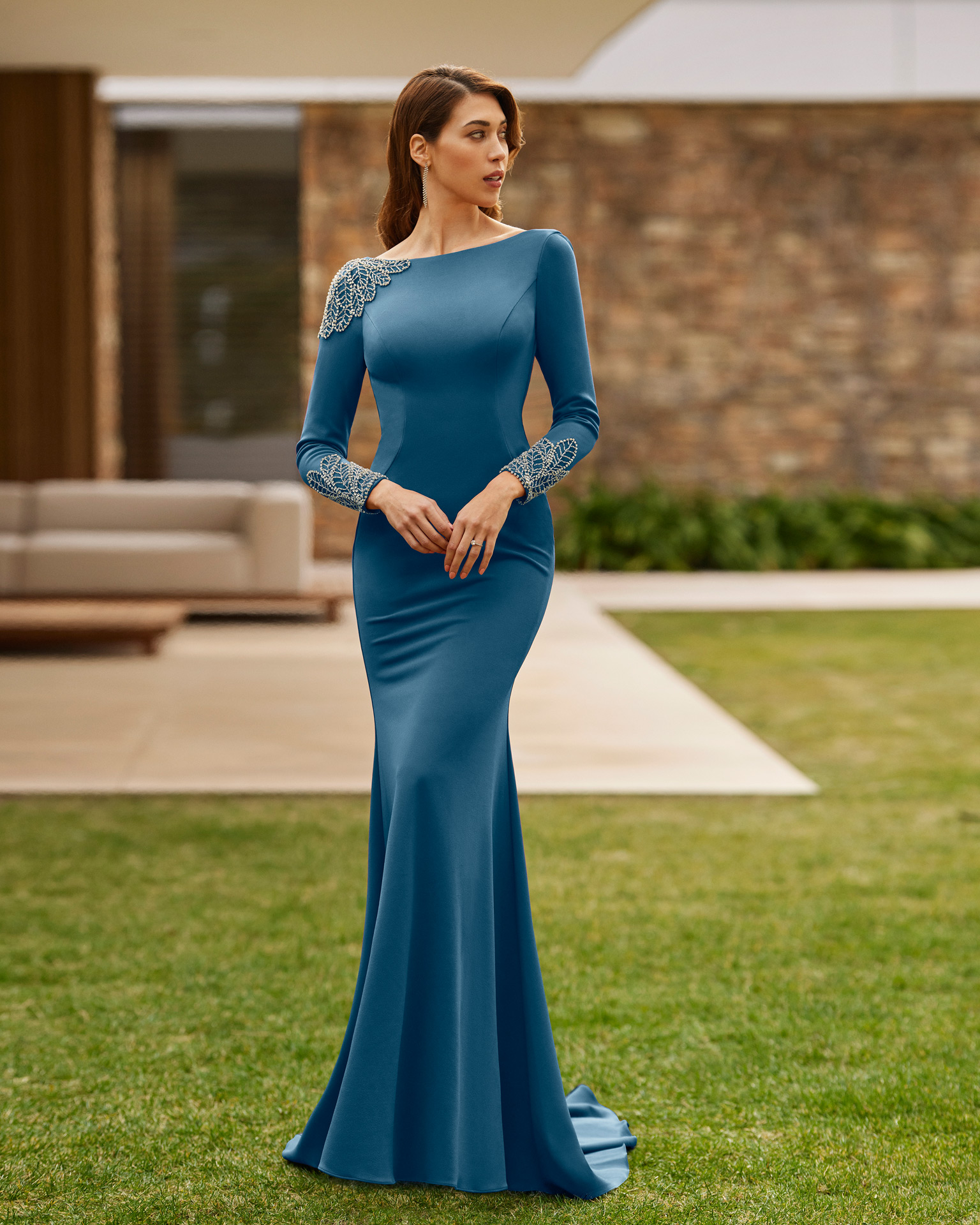 Elegant long evening dress. Made with crêpe embellished with beadwork. With round neckline and plunging back, and long sleeves with beadwork. Marfil Barcelona dreamy look. MARFIL_BARCELONA.