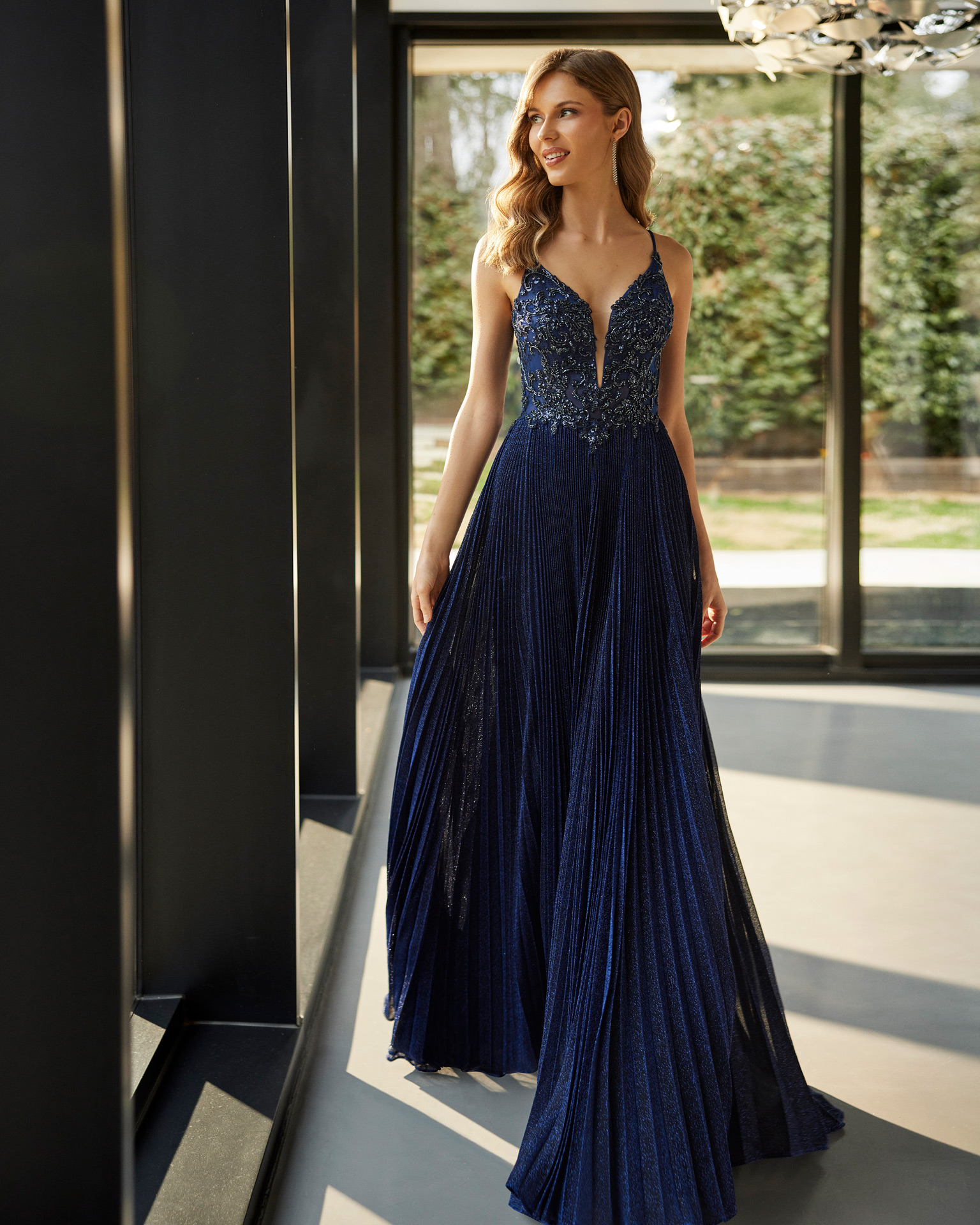 Sexy long evening dress. Crafted with lurex and beadwork lace. With a V-neckline and open back with straps. Marfil Barcelona design for parties and celebrations. MARFIL_BARCELONA.