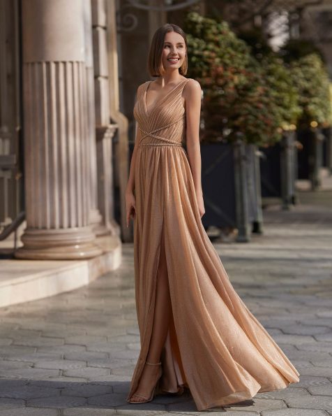 Fluid and simple formal long evening dress, crafted in lurex embellished with beadwork. The V-neckline, straps and a shawl complete the look. A Marfil Barcelona design. MARFIL_BARCELONA.