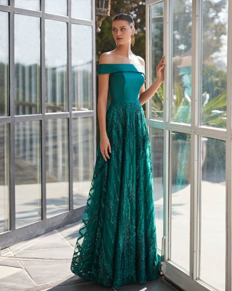 Long evening dress crafted in lace and beadwork. Showcase an off-shoulder neckline, keyhole back and sleeveless bodice. A Marfil Barcelona look. MARFIL_BARCELONA.