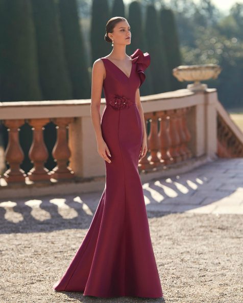 Long evening dress crafted in mikado. Featuring a V-neckline and V-back, flounced straps and a flower embellishment. A Marfil Barcelona look. MARFIL_BARCELONA.