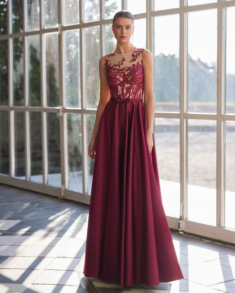 Long evening dress crafted in satin combined with lace and beadwork. Featuring an illusion neckline, back with pearl buttons, and a sleeveless bodice. A Marfil Barcelona look. MARFIL_BARCELONA.