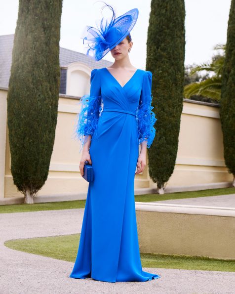 Vestido de fiesta largo, confeccionado en crepé y plumas. Con escote pico, manga francesa y espalda en V. MARFIL_BARCELONA.