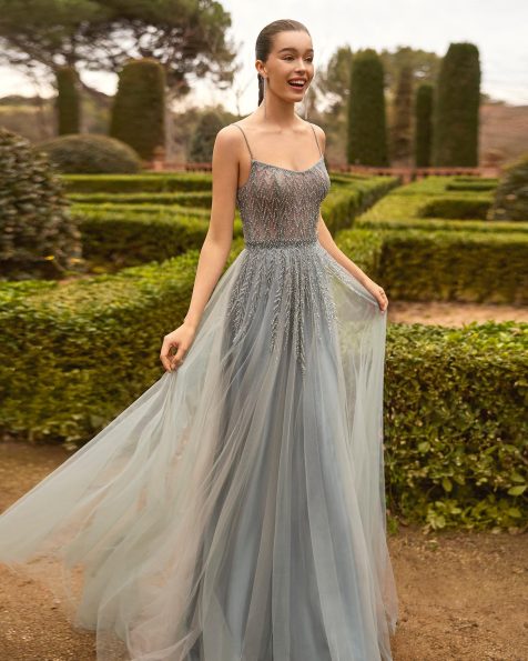 Long cocktail dress, made of tulle and beading, with a straight neckline, beaded straps, and crossed straps on the back with a shawl. MARFIL_BARCELONA.